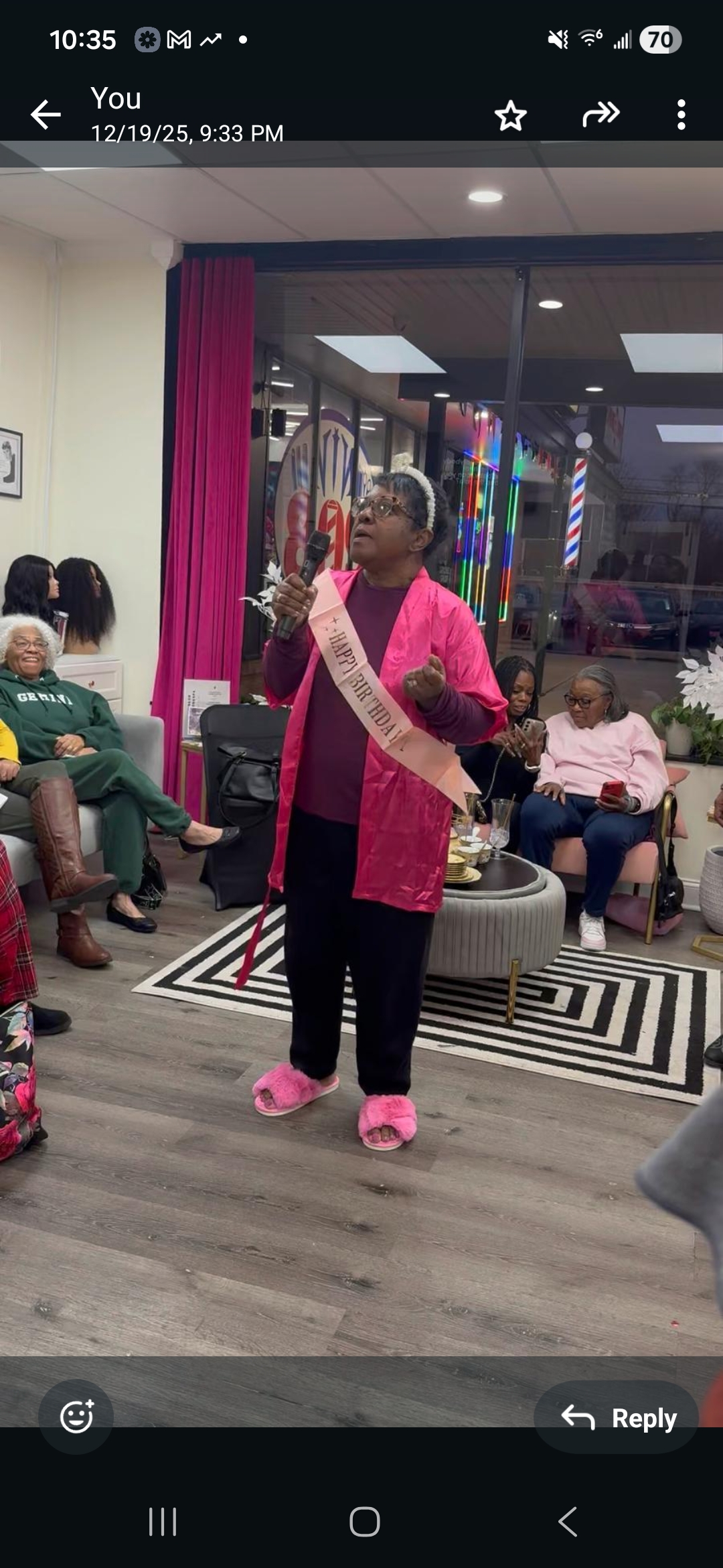 Birthday spa party celebration — birthday honoree with sash and microphone