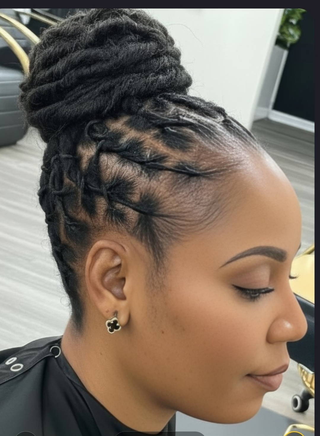 Woman smiling outdoors with curly locs against tropical greenery — natural hair salon Middletown DE